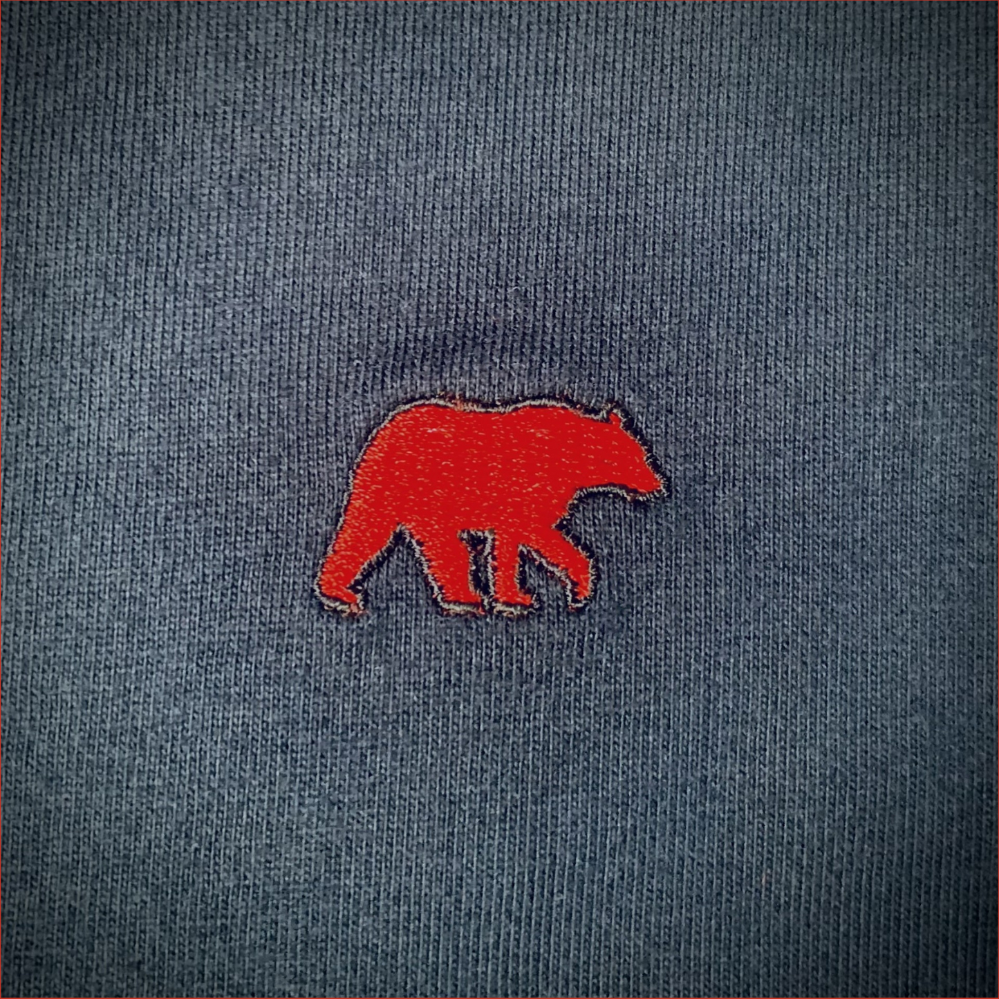 Red bear silhouette on a textured navy background