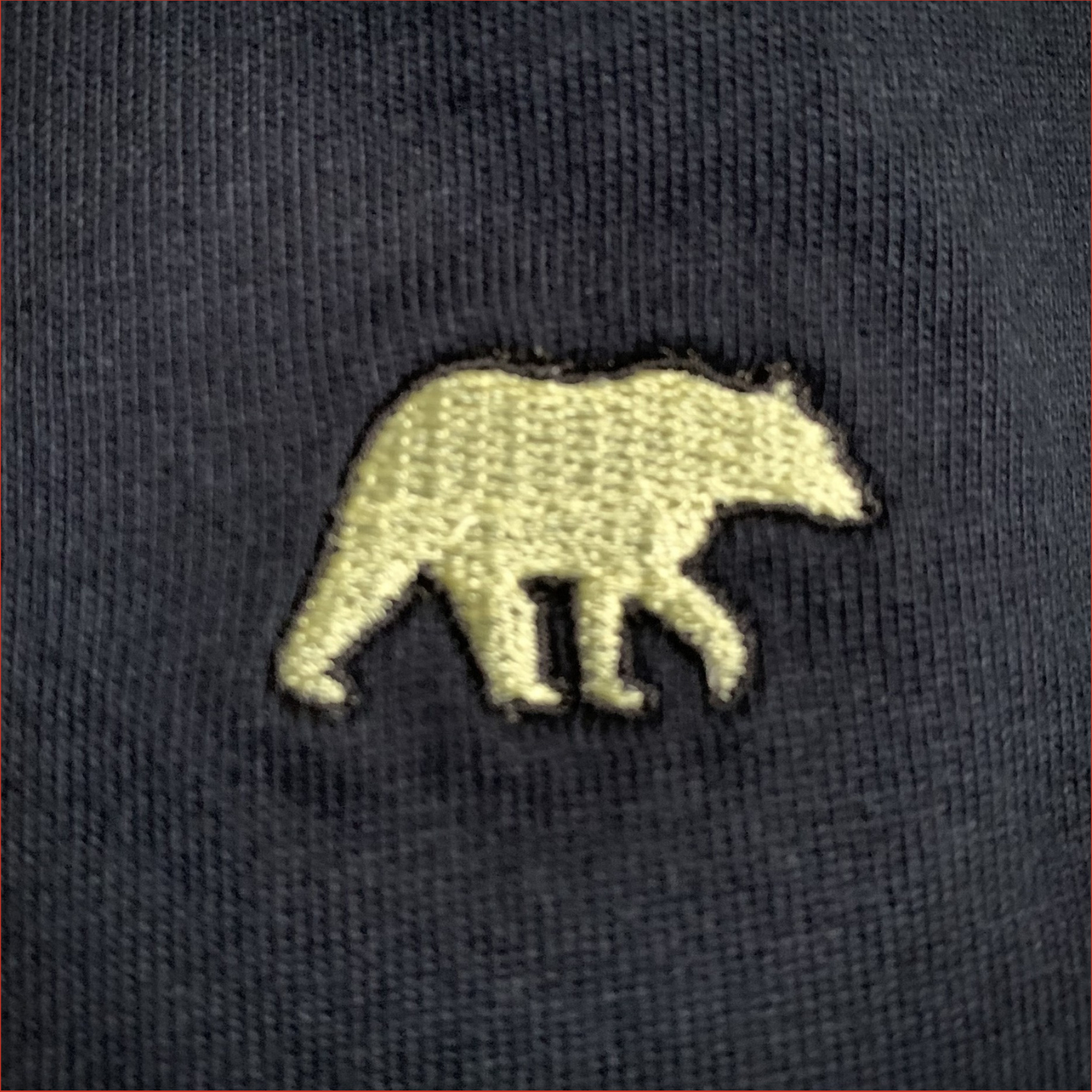 Close up of Embroidered bear design on a navy tshirt by Shoreditch and Hale