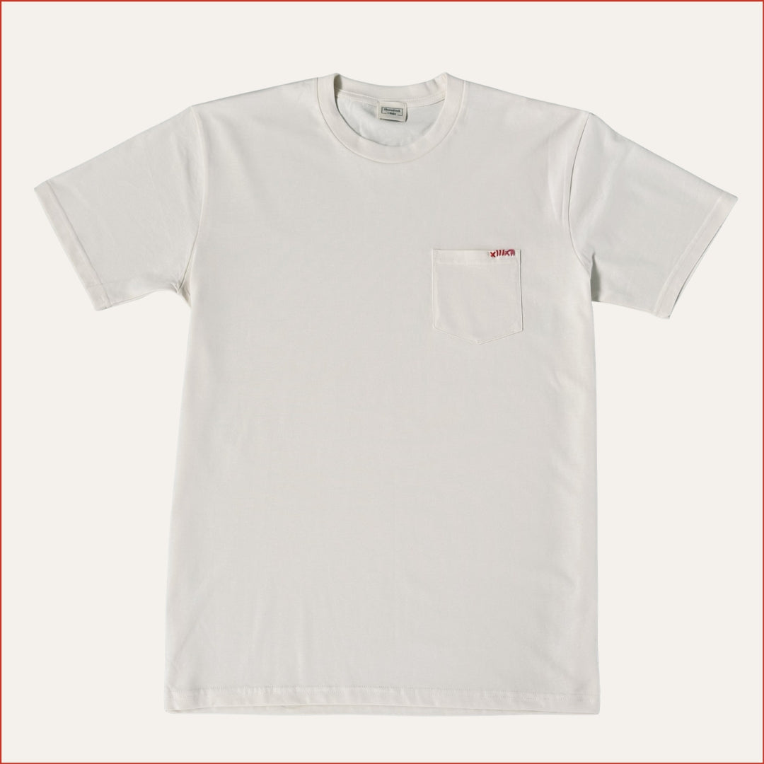 Flat lay image of a soft white ecru pocket t-shirt with detailed red contrast stitching on the chest. Minimalist and understated design by shoreditch and hale