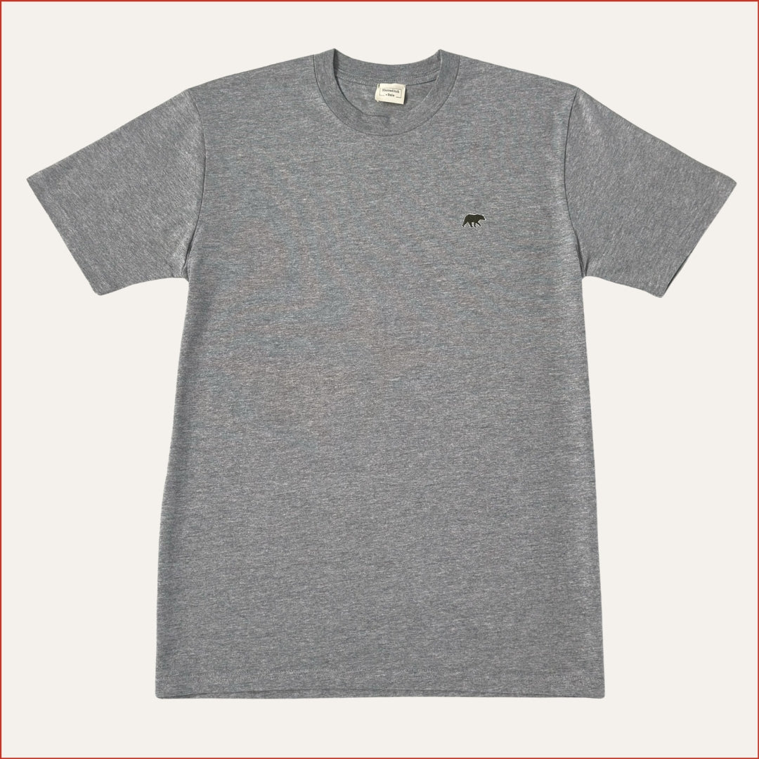 Flat lay image of a Gray shoreditch and hale soft cotton t-shirt with a small olive logo on a white background. minimalist and understated design casual menswear