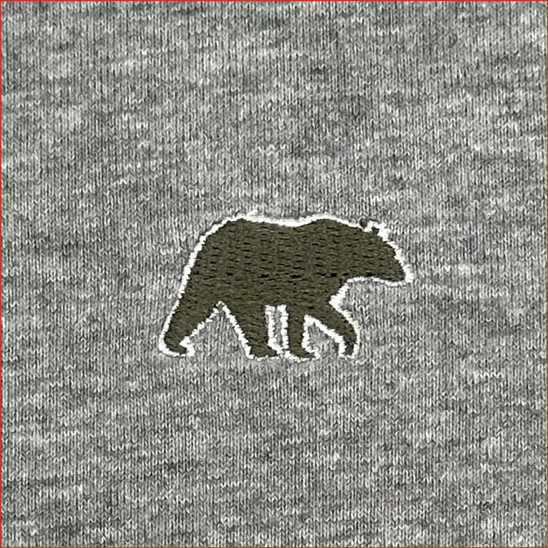 close up image of an Embroidered bear design in olive colour on a gray soft cotton tshirt