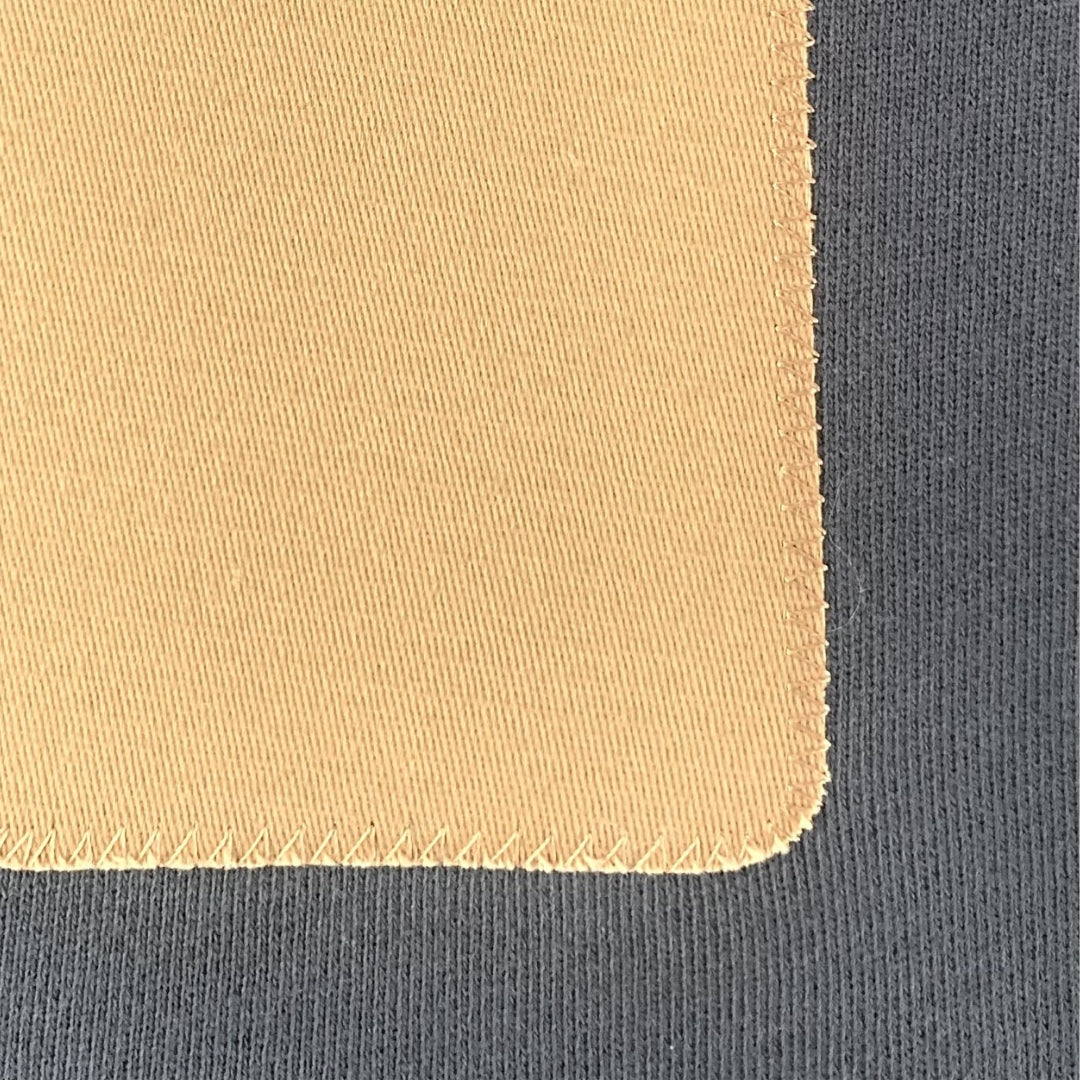 Close up image of a Carbon Blue men's sweatshirt with a brown rectangular patch. Minimalist design casual wear by shoreditch and hale