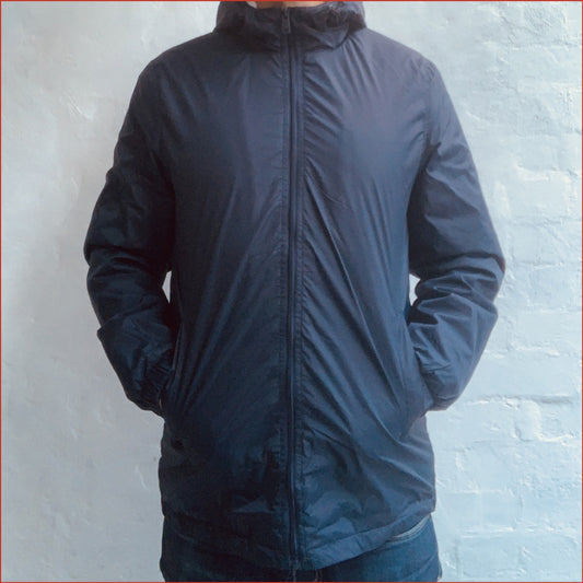 Model wearing a Navy blue Shoreditch and Hale parka against a white background. Minimalist casual design by  Shoreditch and Hale.