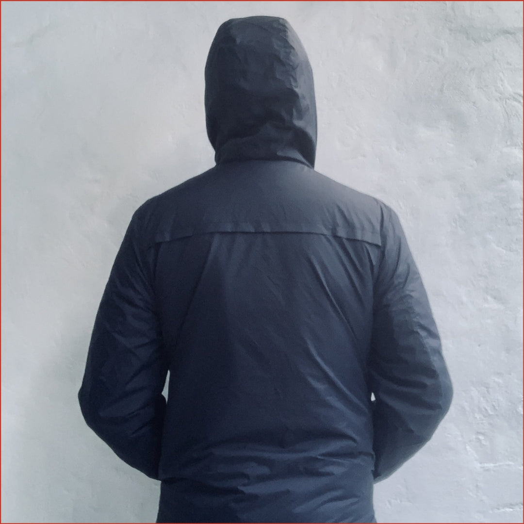 Navy blue Shoreditch and Hale parka against a white background. Minimalist casual design by  Shoreditch and Hale.