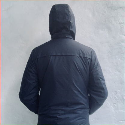 Navy blue Shoreditch and Hale parka against a white background. Minimalist casual design by  Shoreditch and Hale.