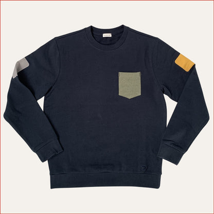 Flat lay image of a men's Navy blue sweatshirt with a pocket and colored arm patches on a light gray background. Designed by Shoreditch and Hale