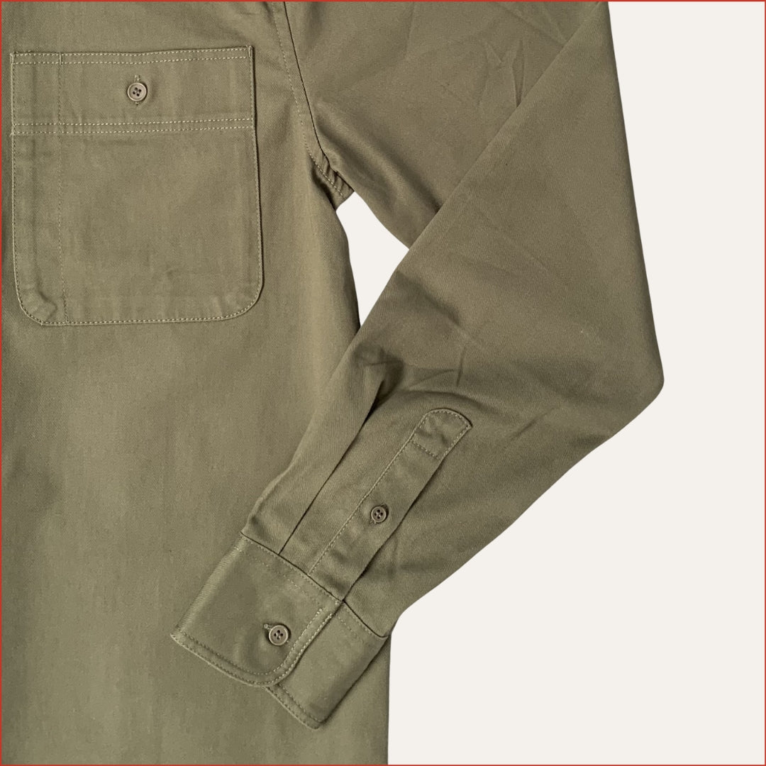 Flat lay image of a khaki cotton drill shirt  on a white background. minimalist and understated design casual menswear shoreditch and hale