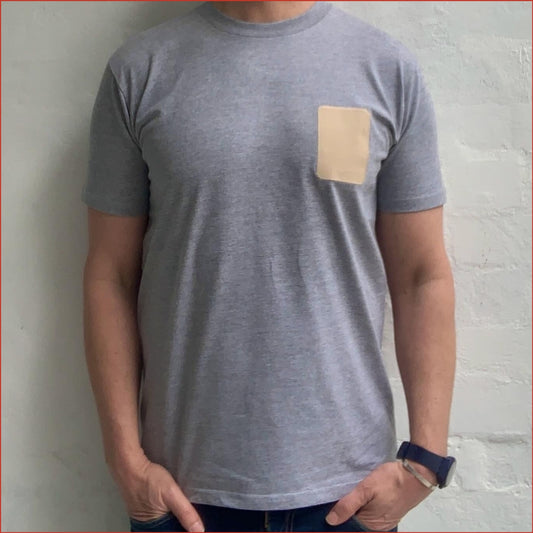 Model wearing Flay a Gray t-shirt with a beige patch on a white background minimalist and understated design by shoreditch and hale